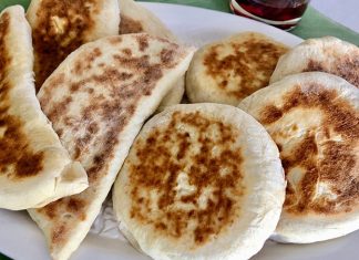 Türk mutfağının en özel ve sevilen ekmek çeşitlerinden biri olan bazlama, yumuşak dokusu, doyurucu yapısı ve mis gibi kokusuyla sofraların vazgeçilmezidir. Özellikle Anadolu’nun birçok bölgesinde kahvaltıların, çay saatlerinin ve hatta ana yemeklerin yanında sıklıkla tercih edilen bu ekmek, sadece lezzetiyle değil kültürel bir değer olarak da öne çıkar. Günümüzde modern sofralarda da kendine yer bulan bazlama, hem geleneksel hem de pratik bir lezzet olarak dikkat çekmektedir. Konulu bir haber görseli.