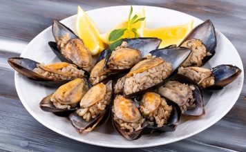 Midye Dolma: Sokakların Vazgeçilmez Lezzeti Türk mutfağının en bilinen sokak lezzetlerinden biri olan midye dolma, kökeni Osmanlı dönemine kadar uzanan köklü bir geçmişe sahiptir. Saray mutfağında farklı baharatlarla hazırlanan pirinçli yemeklerin deniz ürünleriyle birleşmesi sonucu ortaya çıktığı düşünülmektedir. Zamanla bu lezzet, sokaklara taşınarak herkesin ulaşabileceği bir hale gelmiştir. Konulu bir haber görseli.