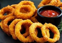 Soğan halkası, fast food kültürünün en sevilen atıştırmalıklarından biri olarak öne çıkıyor. Tarihi 20. yüzyılın ortalarına dayanan bu lezzet, özellikle Amerika’da popülerlik kazanmış ve kısa sürede dünya mutfaklarına yayılmıştır. Patates kızartmaları ve burgerlerin yanında ikincil lezzet olarak sunulan soğan halkaları, hem çıtır dokusu hem de tatlımsı soğan aroması ile dikkat çekiyor. Konulu bir haber görseli.